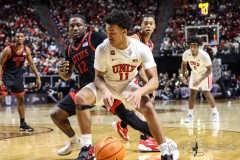 March 14, 2024: San Diego State Aztecs guard Darrion Trammell (12) defends UNLV Rebels guard Dedan Thomas Jr. (11) during the second half of the Men’s Quarterfinals of the Mountain West Conference tournament, Thursday, March 14, 2024, in Las Vegas, NV. Christopher Trim/A Lot of Sports Talk.