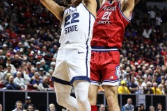 March 14, 2024: Utah State Aggies guard Javon Jackson (22) shoots over Fresno State Bulldogs guard Isaiah Pope (21) during the second half of the Men’s Quarterfinals of the Mountain West Conference tournament, Thursday, March 14, 2024, in Las Vegas, NV. Christopher Trim/A Lot of Sports Talk.