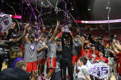March 16, 2024: New Mexico Lobos head coach Richard Pitino raises the trophy and celebrates with his team on stage after winning the Men’s Mountain West Conference tournament, Saturday, March 16, 2024, in Las Vegas, NV. Christopher Trim/A Lot of Sports Talk.
