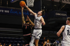 March 09, 2026: Washington DC: Monmouth Hawks guard Jack Collins (13) blocks a shot during the semi final round of the  2026 Air Force Reserve CAA Men\'s Basketball Championship game at CareFirst Arena in Washington, DC. (Michael R. Smith).