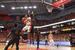 During the ACC conference basketball game between Syracuse University and Miami University, Syracuse forward CHRIS BELL (4) flies through the air putting up a contested shot during the first half of the game held at the JMA Wireless Dome on the campus of Syracuse University.