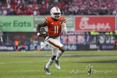 During the 13th annual  BAD BOY MOWERS PINSTRIPE BOWL  between Big Ten conference Rutgers University and Atlantic Coast Conference University of Miami,  Miami quarterback JACURRI BROWN (11) rushes for a touchdown during the first half of the game at Yankee Stadium in The Bronx.