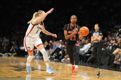 NEW YORK — DECEMBER 7:  Louisville Cardinals Guard Tajianna Roberts (22) passes the ball against UConn Huskies Guard Paige Bueckers (5) during the first half at the Barclays Center on December 7, 2024, in New York, New York. (Gregory Fisher/A Lot of Sports Talk)