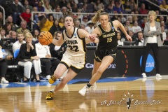 ALBANY, NEW YORK – MARCH 30:  Iowa guard CAITLIN CLARK (22) drives past Colorado defender KINDYLL WETTA (15) during the 2024 NCAA Women’s Basketball Tournament Albany 2 Regional semifinal at MVP Arena on March 30, 2024, in Albany, N.Y.  (Scotty Rausenberger/A Lot of Sports Talk)