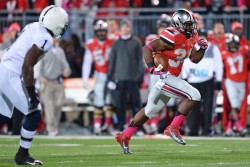 Just like what they did to Penn State last week, Carlos Hyde (r.) and the Buckeyes are looking to run away from the rest of their competition. (Jamie Sabau/Getty Images)