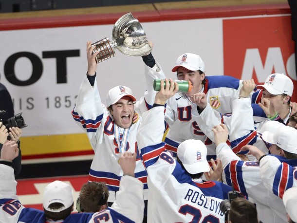 After a thrilling run in the World Junior Championships, Luke Kunin (c.) was able to hold the championship trophy aloft for Team USA after it beat Team Canada in the gold medal match last month. (Paul Chiasson/Canadian Press)