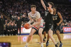 MANHATTAN, NEW YORK — March 14:   UConn center DONOVAN CLINGAN (32) looks to pass on the baseline during the first half of the Big East Tournament Quarterfinal game against Xavier at Madison Square Garden on March 14, 2024, in Manhattan, N.Y. (Scotty Rausenberger/A Lot of Sports Talk)2q