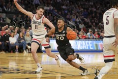 MANHATTAN, NEW YORK — March 14:  Xavier guard DAYVION MCKNIGHT (20) drives past a  UConn defender during the second half of the Big East Tournament Quarterfinal game against UConn at Madison Square Garden on March 14, 2024, in Manhattan, N.Y. (Scotty Rausenberger/A Lot of Sports Talk)