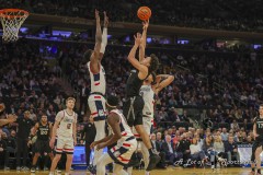 MANHATTAN, NEW YORK — March 14:  Xavier guard DESMOND CLAUDE (1) puts up a floater over a UConn defender during the second half of the Big East Tournament Quarterfinal game against UConn at Madison Square Garden on March 14, 2024, in Manhattan, N.Y. (Scotty Rausenberger/A Lot of Sports Talk)