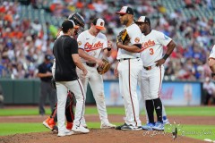 BALTIMORE — JULY 11: Baltimore Orioles pitching coach Drew French (75) visits the mound to speak with Baltimore Orioles pitcher Albert Suarez (49) during the fifth inning against the Chicago Cubs inside Oriole Park at Camden Yards on July 11, 2024, in Baltimore, Maryland. (Gregory Fisher/A Lot of Sports Talk)