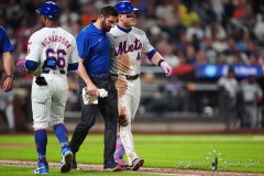 NEW YORK — JULY 29: New York Mets center fielder Harrison Bader (44) walks to first base with the trainer after getting hit by a pitch in the ankle during the sixth inning against the Minnesota Twins at Citi Field on July 29, 2024, in New York, New York. (Gregory Fisher/A Lot of Sports Talk)