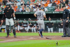 BALTIMORE — JULY 12: New York Yankees shortstop Anthony Volpe (11) scores a run on New York Yankees catcher Jose Trevino (not pictured) RBI double against the Baltimore Orioles during the second inning inside Oriole Park at Camden Yards on July 12, 2024, in Baltimore, Maryland. (Gregory Fisher/A Lot of Sports Talk)